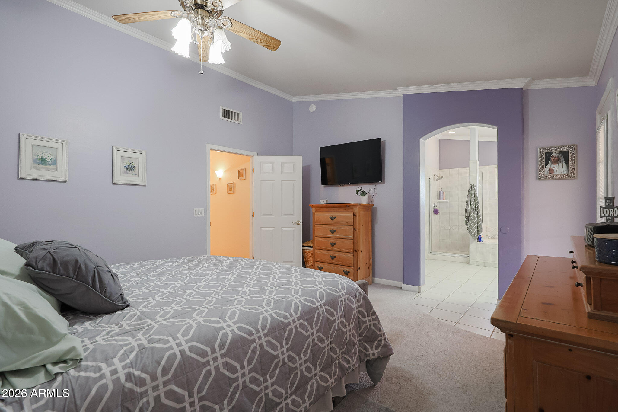 7344 North Alsup Road Litchfield Park, AZ 85340 - Photo 30 of 62 a bedroom with a bed and a flat tv screen on dresser