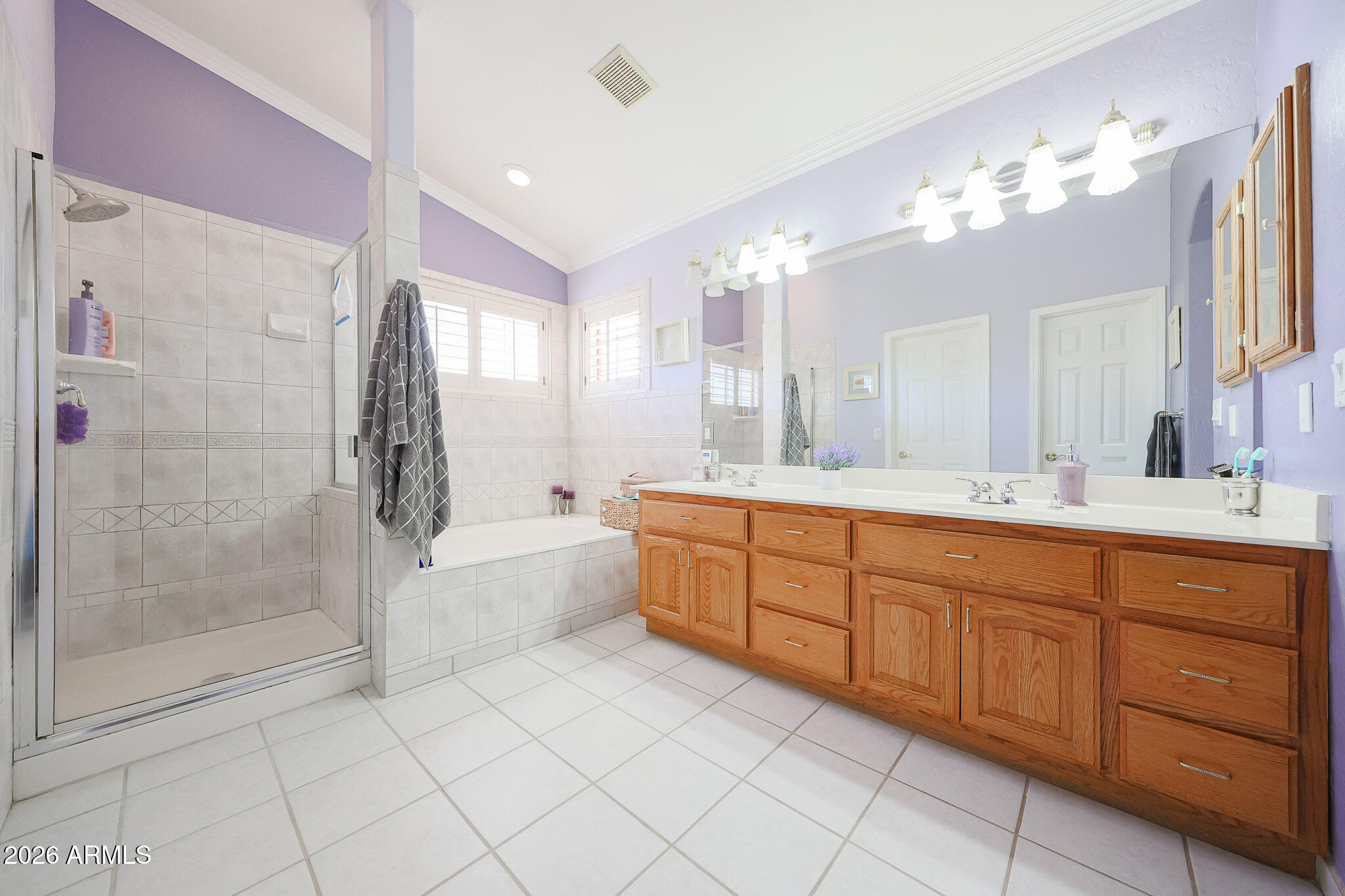 7344 North Alsup Road Litchfield Park, AZ 85340 - Photo 32 of 62 a spacious bathroom with a mirror a sink and a glass door shower