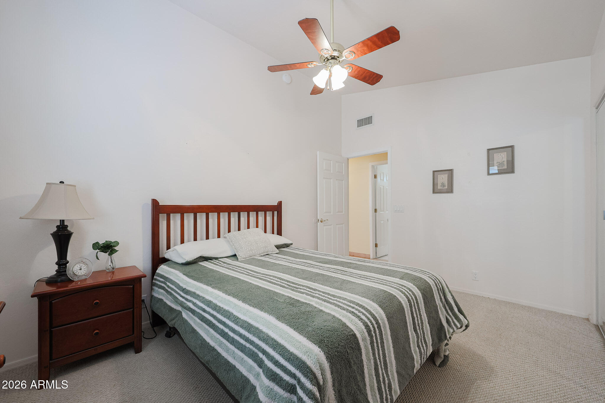 7344 North Alsup Road Litchfield Park, AZ 85340 - Photo 38 of 62 a bedroom with a bed and a chandelier