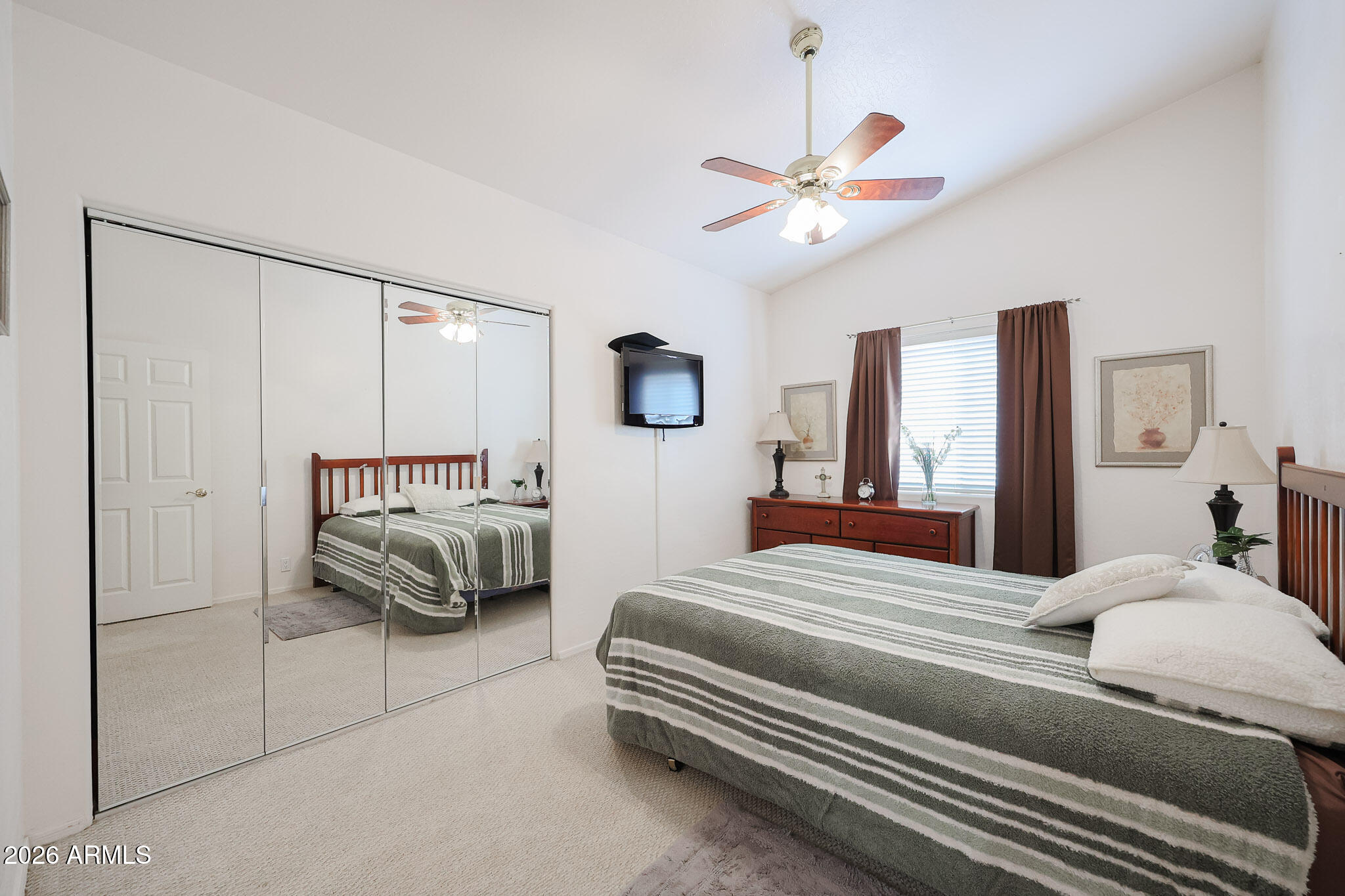 7344 North Alsup Road Litchfield Park, AZ 85340 - Photo 39 of 62 a bedroom with a bed and a chandelier