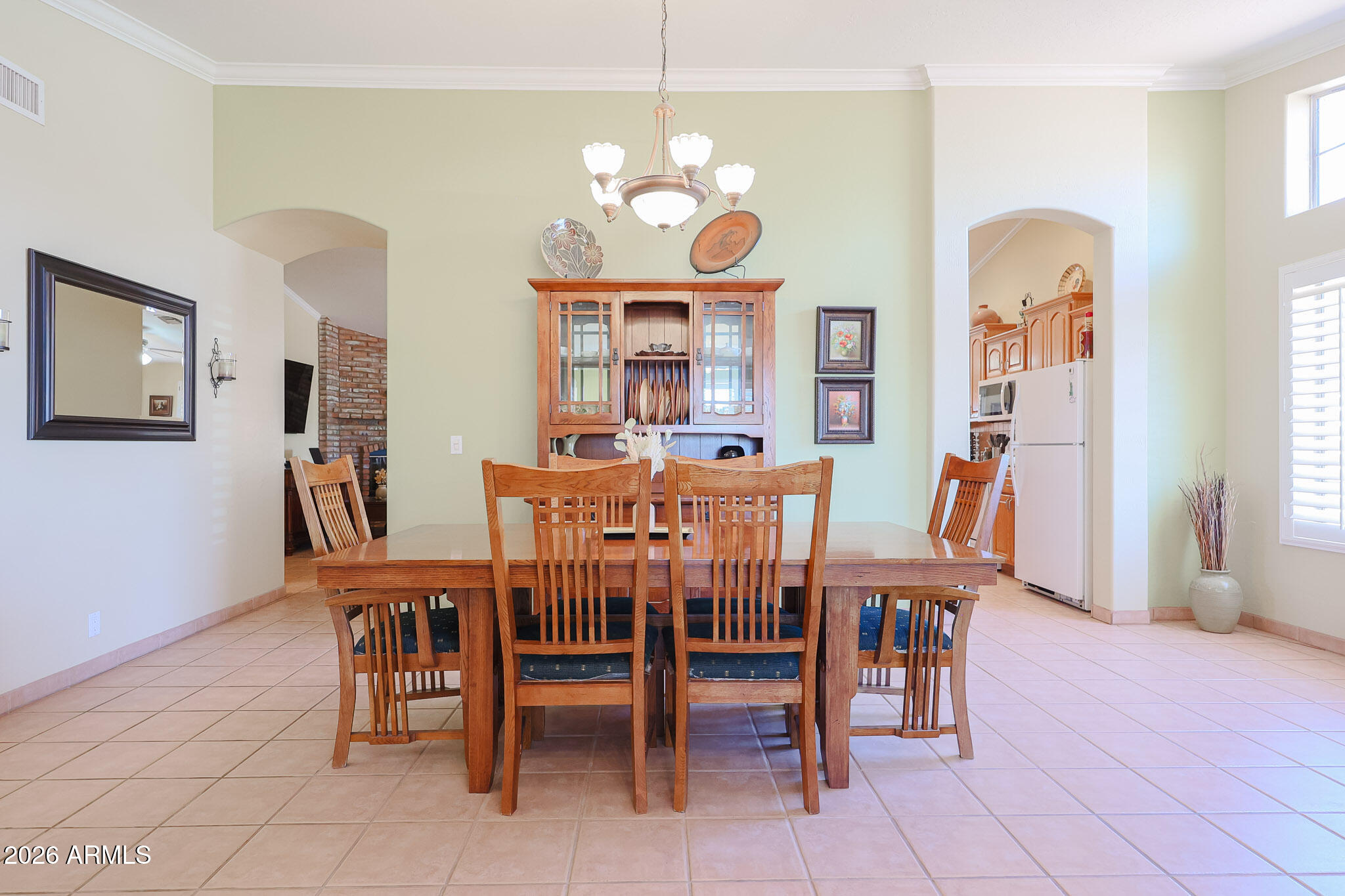 7344 North Alsup Road Litchfield Park, AZ 85340 - Photo 10 of 62 a view of a dining room with furniture and chandelier
