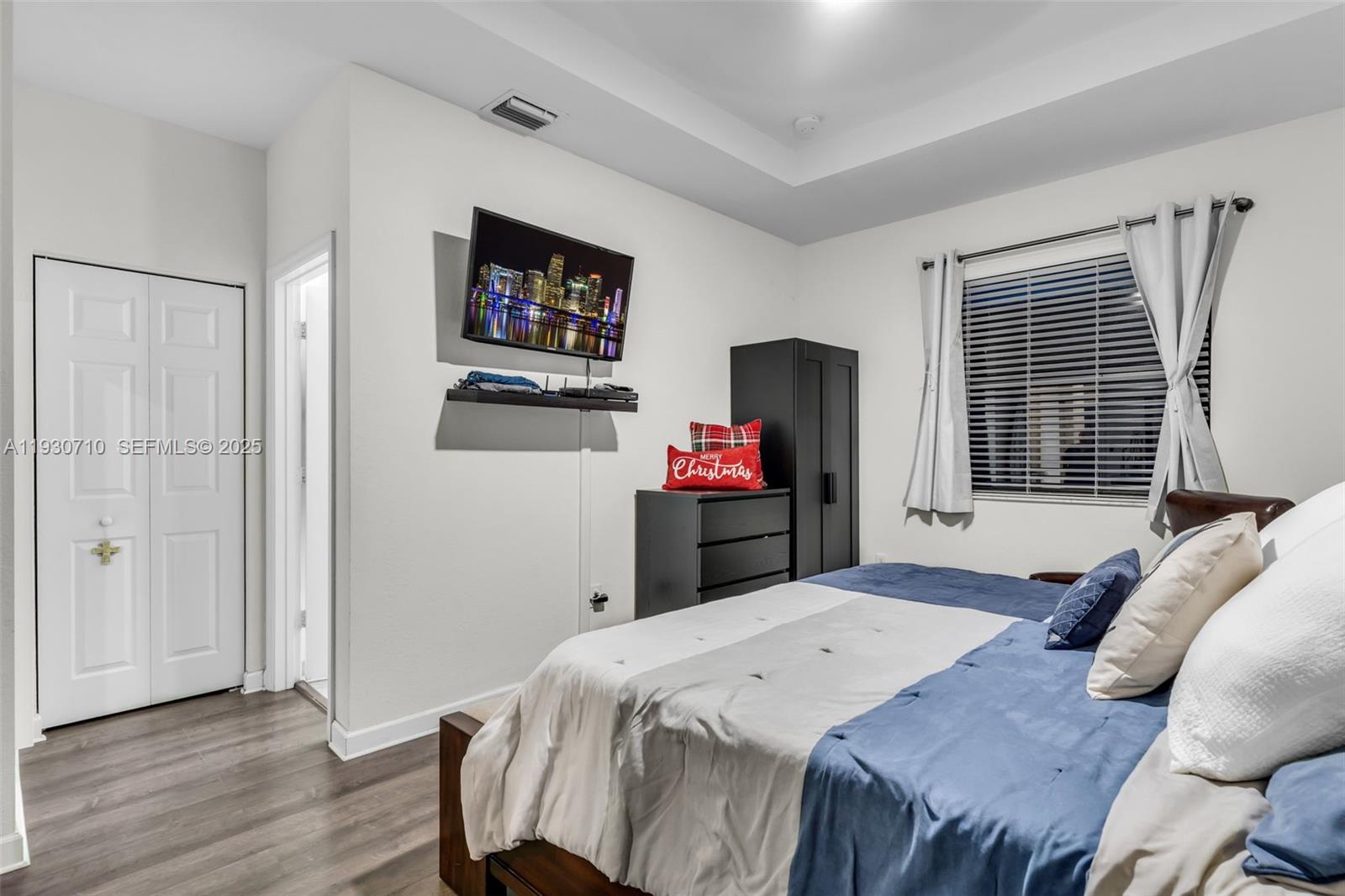 11424 Southwest 251st Street Homestead, FL 33032 - Photo 17 of 43 a bed room with a bed mirror and a window