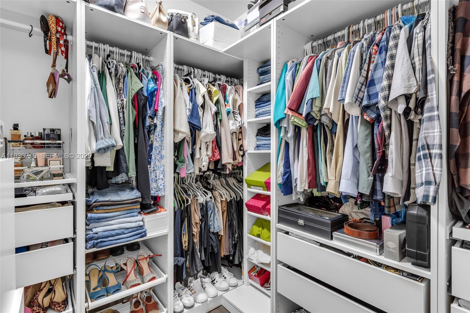 11424 Southwest 251st Street Homestead, FL 33032 - Photo 19 of 43 a view of walk in closet with clothes and shoes