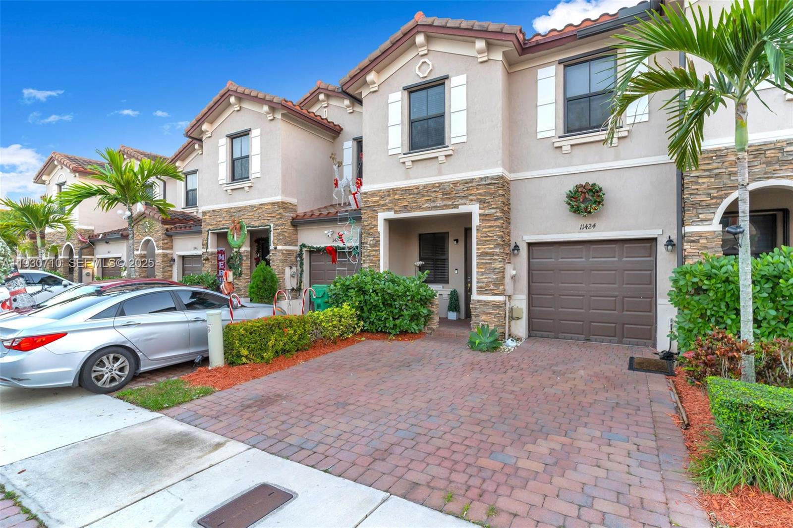 11424 Southwest 251st Street Homestead, FL 33032 - Photo 2 of 43 a front view of a house with a yard and garage