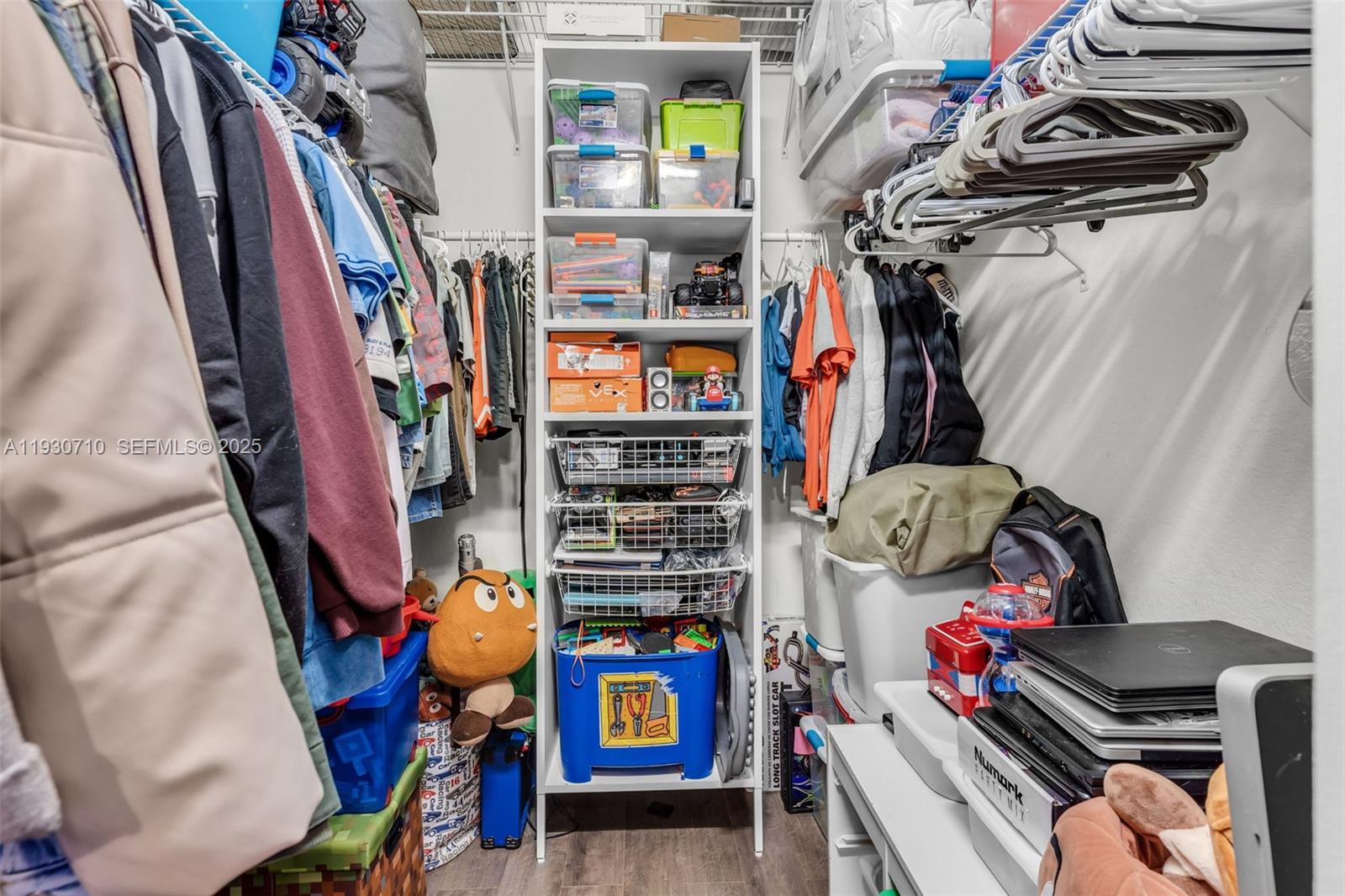 11424 Southwest 251st Street Homestead, FL 33032 - Photo 27 of 43 a view of walk in closet with clothes and shoes