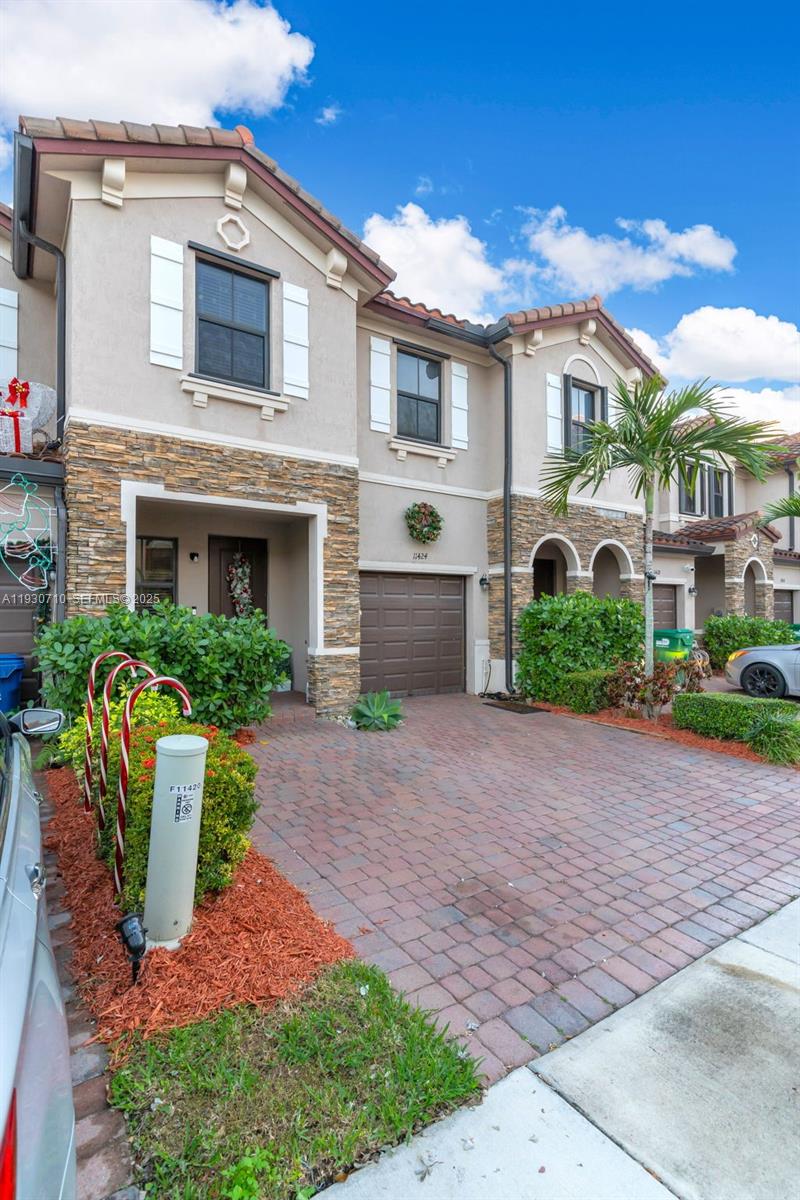 11424 Southwest 251st Street Homestead, FL 33032 - Photo 3 of 43 a front view of a house with a yard and potted plants
