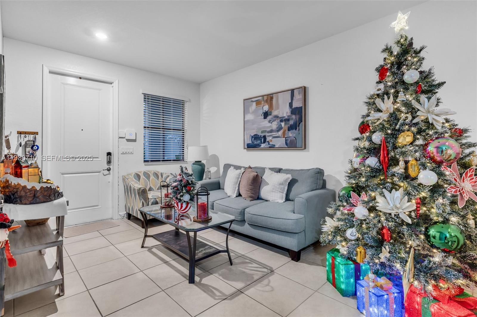 11424 Southwest 251st Street Homestead, FL 33032 - Photo 5 of 43 a living room with furniture and flowers