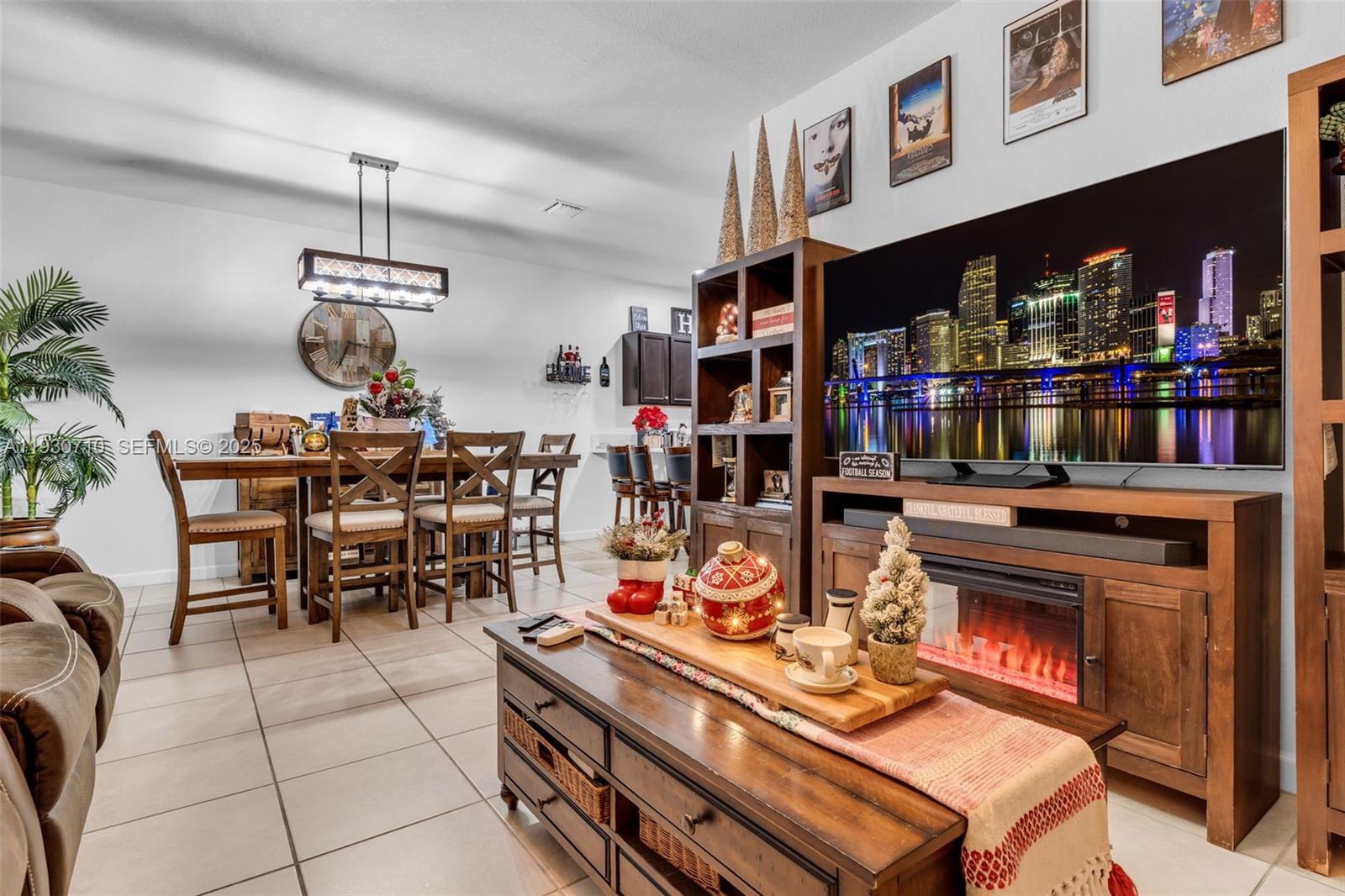 11424 Southwest 251st Street Homestead, FL 33032 - Photo 10 of 43 a living room with lots of furniture and a chandelier