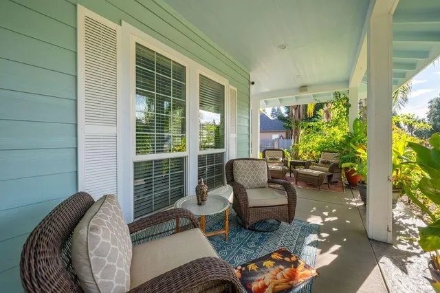 a bedroom with furniture and a large window