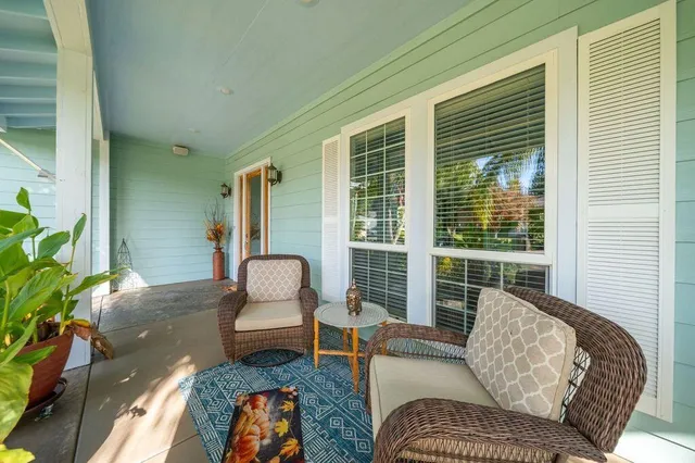 a living room with furniture and large windows