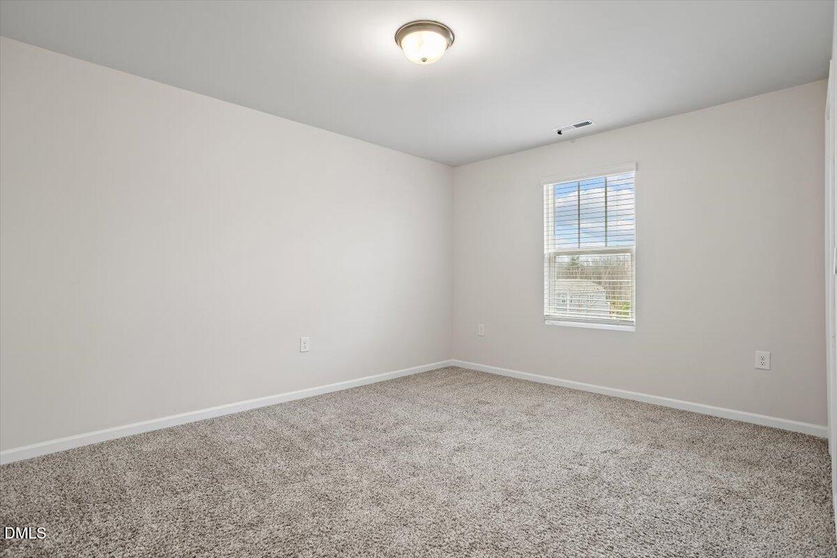 46 Coffee Tree Circle Clayton, NC 27527 - Photo 30 of 36 an empty room with windows
