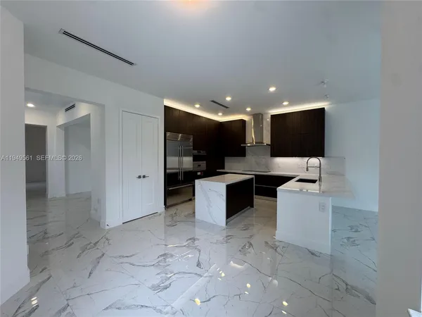 a bathroom with a sink shower and a toilet