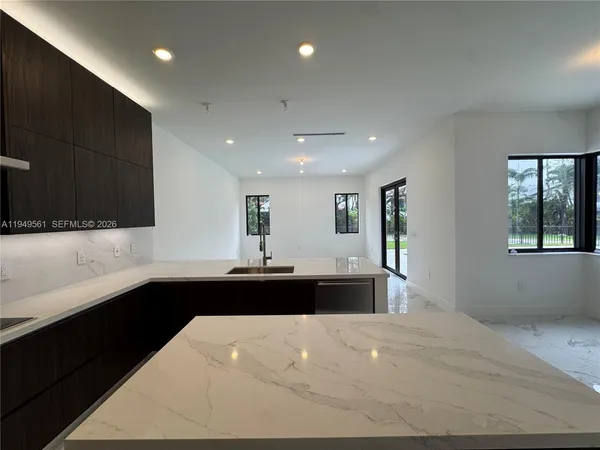 an empty room with wooden floor and window
