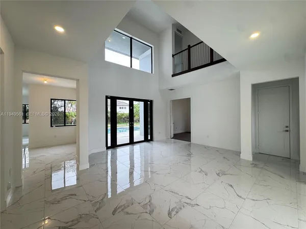 a view of a kitchen with a sink and a large window in a room