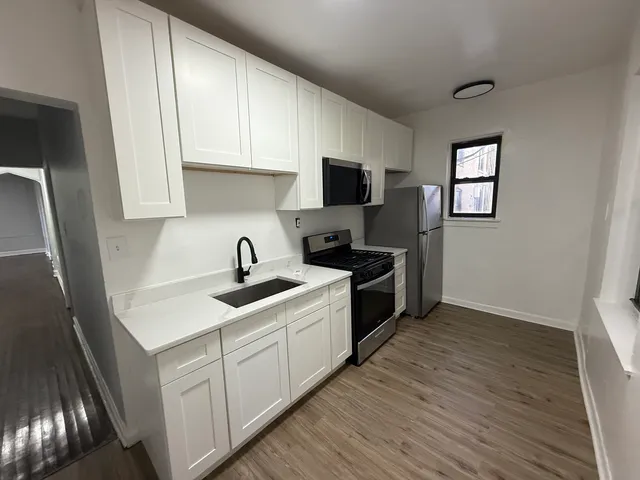 a kitchen with a sink and cabinets