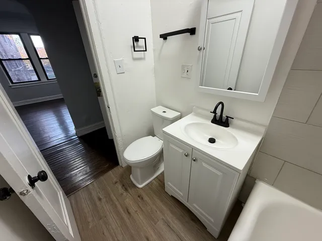 a bathroom with a toilet sink and mirror