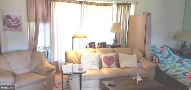 a view of empty room with wooden floor and fireplace