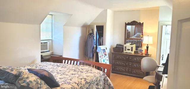 a bedroom with a large bed and a window