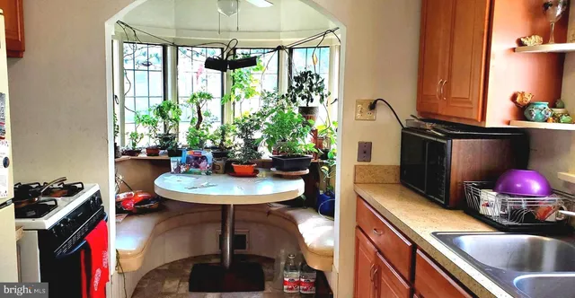 a view of a kitchen area with wooden floor and glass windows