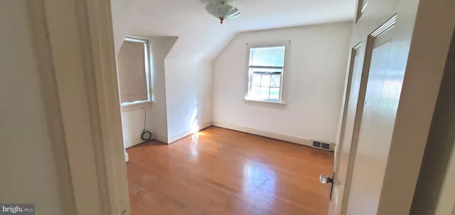 a view of a porch with chairs and potted plants