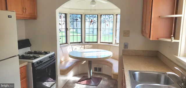 a kitchen with sink refrigerator and window