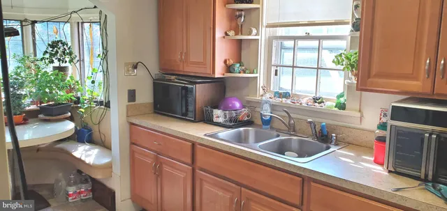 a dining room with furniture and a floor to ceiling window