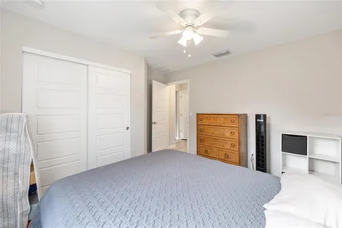a bedroom with a large bed and a chandelier