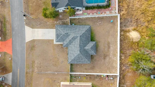 an aerial view of a house with a yard