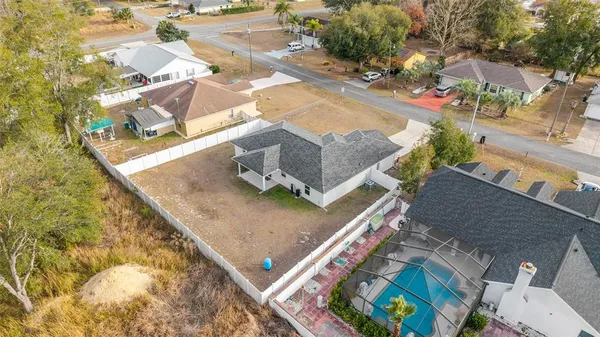 an aerial view of residential houses with outdoor space