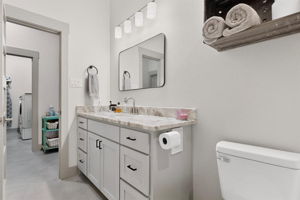 613 Kentucky Town Road Whitewright, TX 75491 - Photo 16 of 39 a bathroom with a granite countertop sink and a mirror