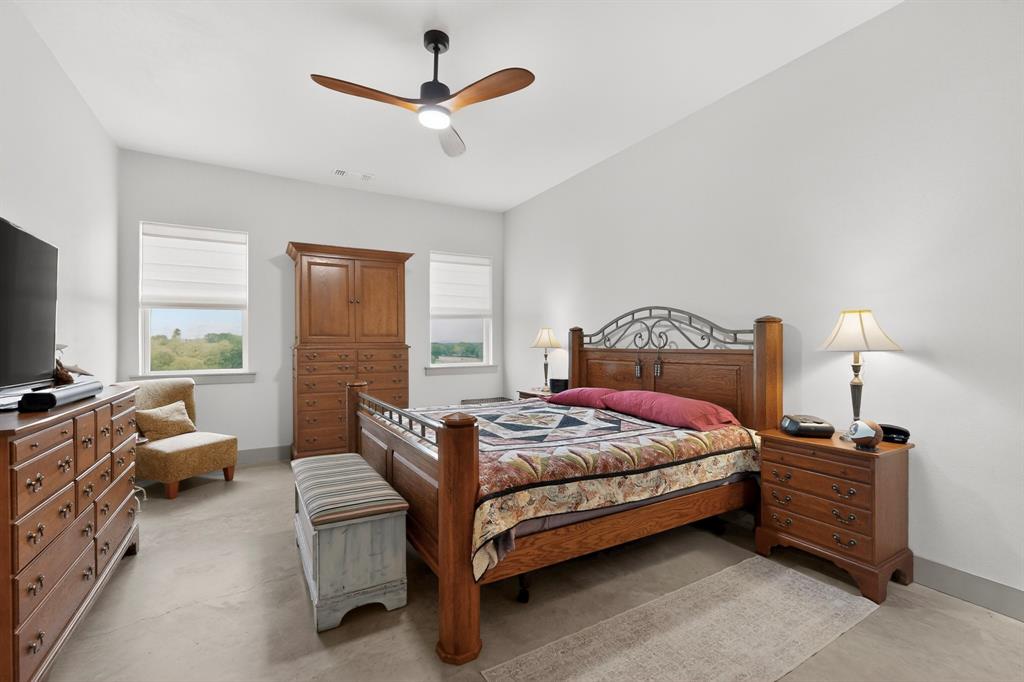 613 Kentucky Town Road Whitewright, TX 75491 - Photo 17 of 39 a bedroom with a bed a couch and a large window