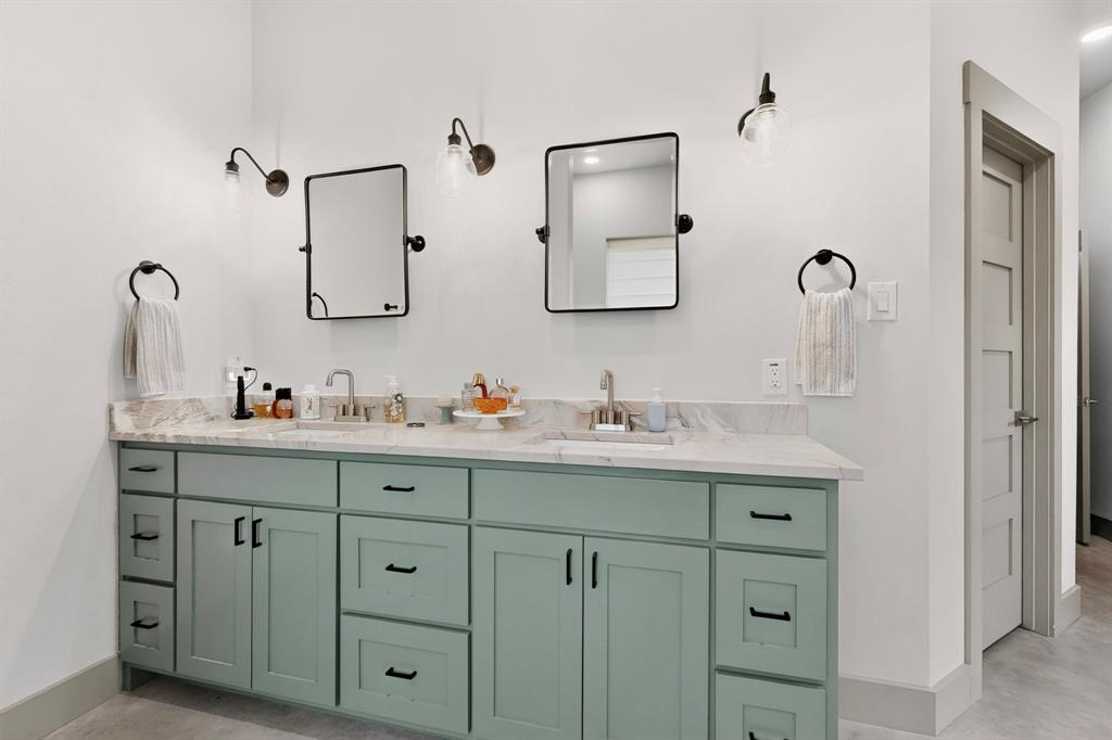613 Kentucky Town Road Whitewright, TX 75491 - Photo 18 of 39 a bathroom with double vanity sinks and a mirror