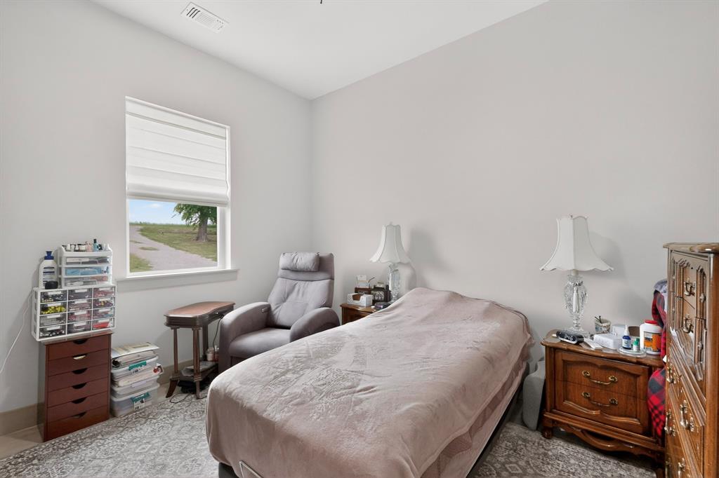 613 Kentucky Town Road Whitewright, TX 75491 - Photo 21 of 39 a bedroom with a bed and a window