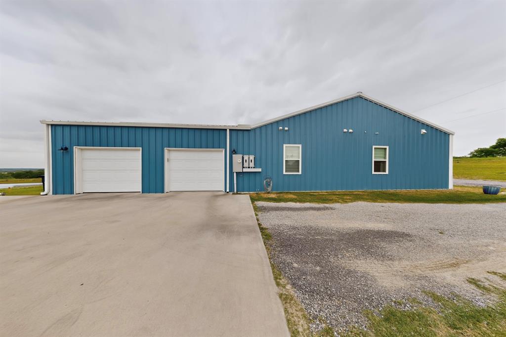 613 Kentucky Town Road Whitewright, TX 75491 - Photo 33 of 39 a view of a big room with a garage
