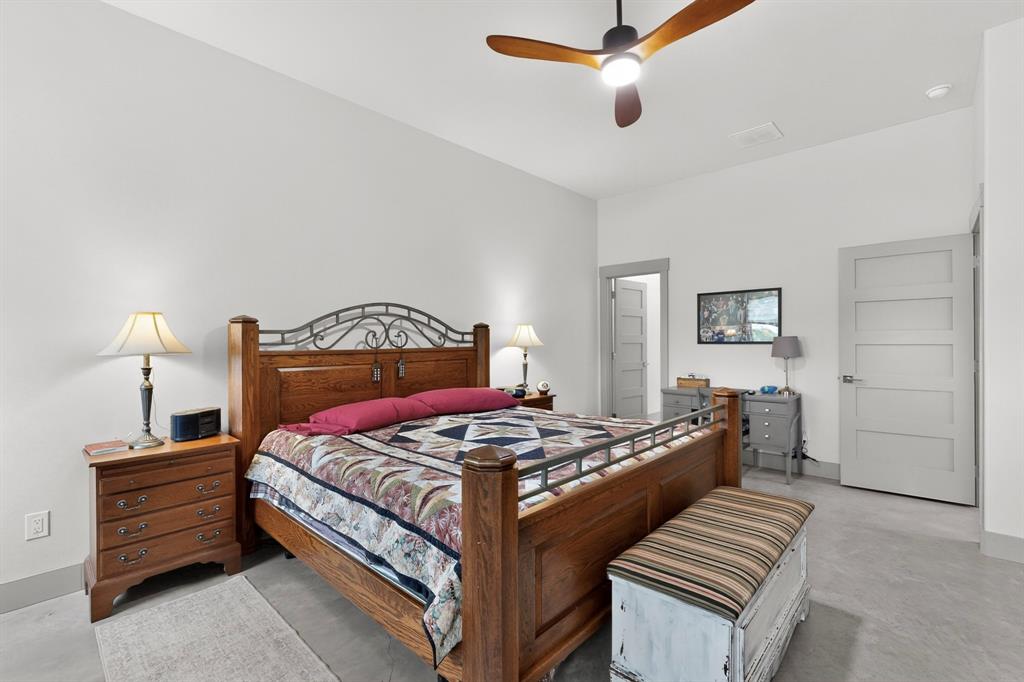 613 Kentucky Town Road Whitewright, TX 75491 - Photo 7 of 39 a bedroom with a bed and a lamp on a dresser