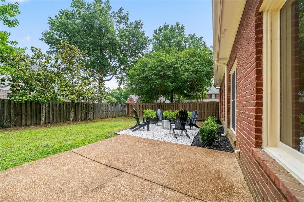 1876 Liles Lane Collierville, TN 38017 - Photo 25 of 36 Red brick exterior with white trim windows and a concrete patio