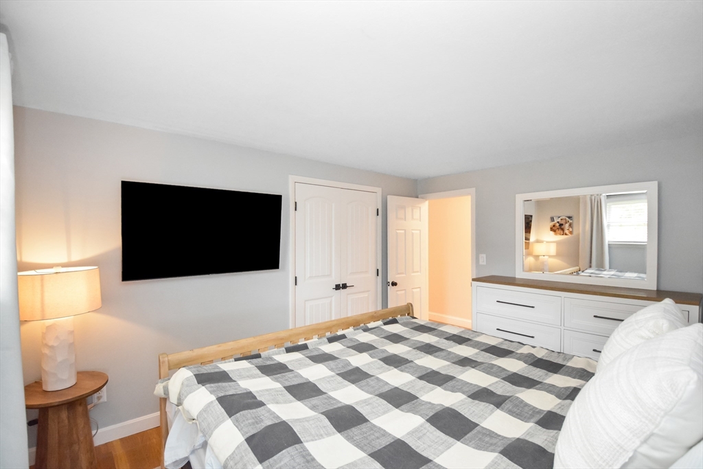 360 High Street Whitman, MA 02382 - Photo 18 of 33 a bedroom with a bed and a flat screen tv