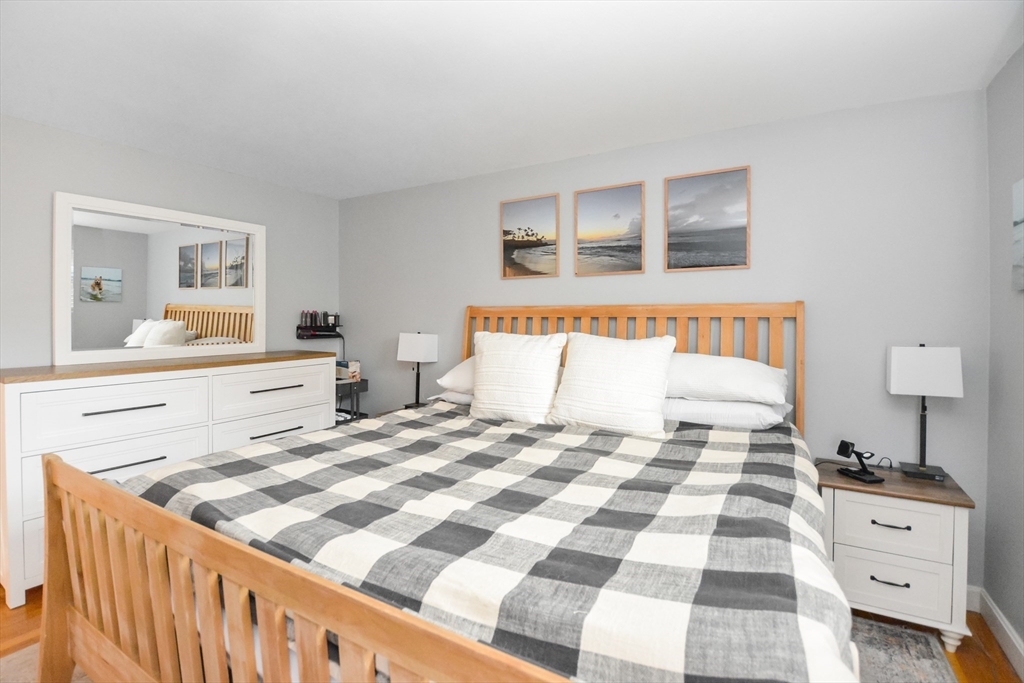 360 High Street Whitman, MA 02382 - Photo 19 of 33 a bedroom with a bed and wooden floor