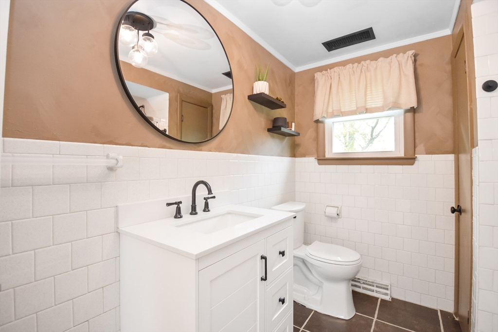 360 High Street Whitman, MA 02382 - Photo 10 of 33 a bathroom with a sink and a mirror