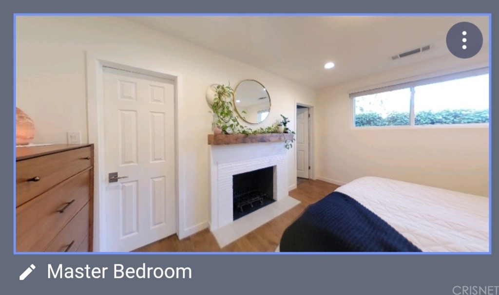 14721 Weddington Street Sherman Oaks, CA 91411 - Photo 12 of 17 a living room with a fireplace wooden floor and a table