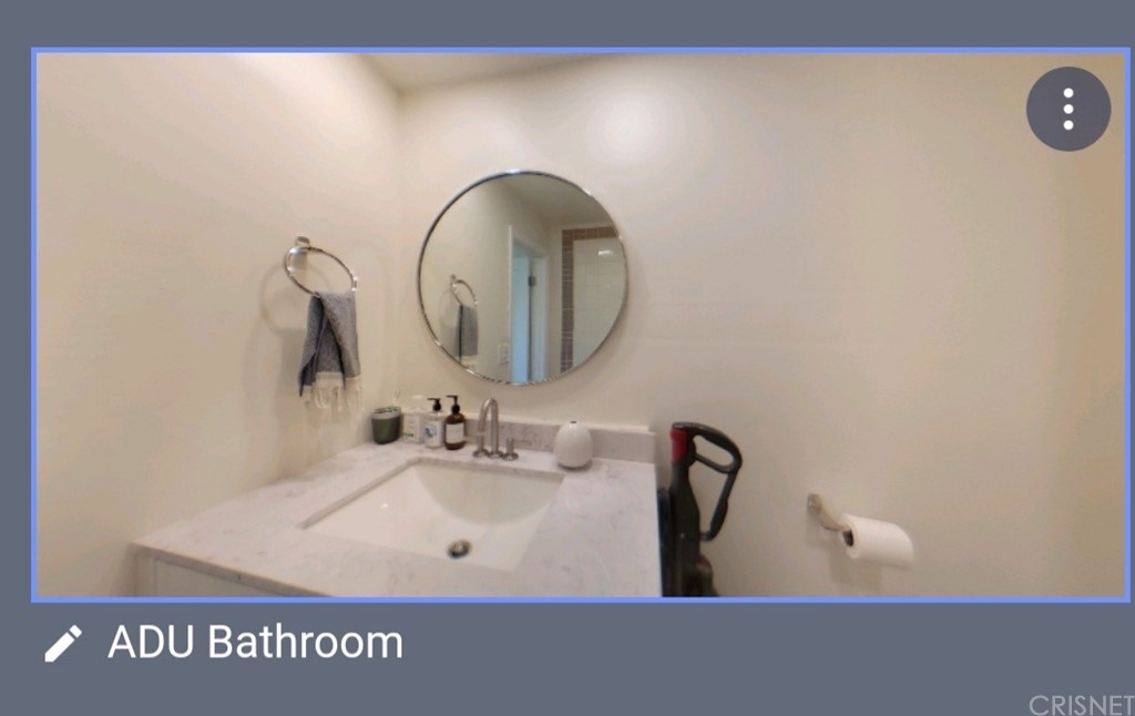 14721 Weddington Street Sherman Oaks, CA 91411 - Photo 14 of 17 a bathroom with a sink and a mirror