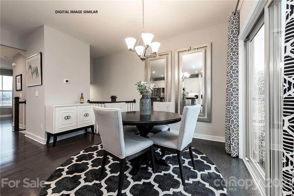 904 Portrush Lane, Unit 1015E Tega Cay, SC 29708 - Photo 3 of 12 a dining room with a table and chairs