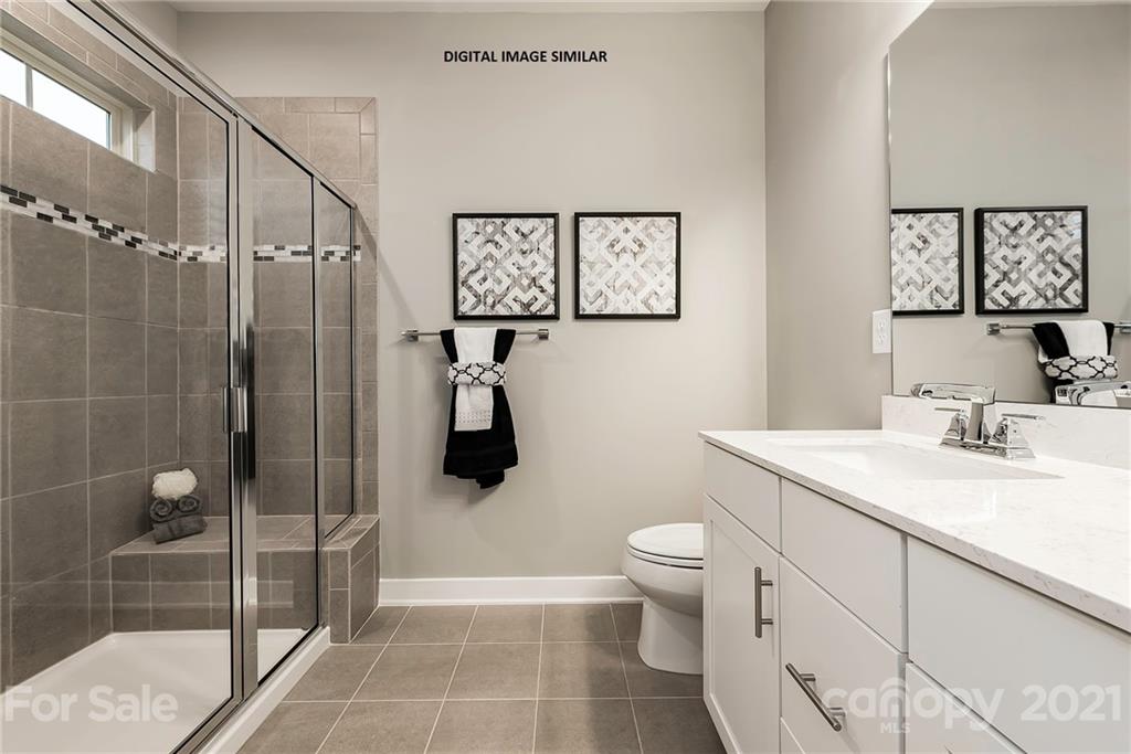904 Portrush Lane, Unit 1015E Tega Cay, SC 29708 - Photo 8 of 12 a bathroom with a sink toilet and shower