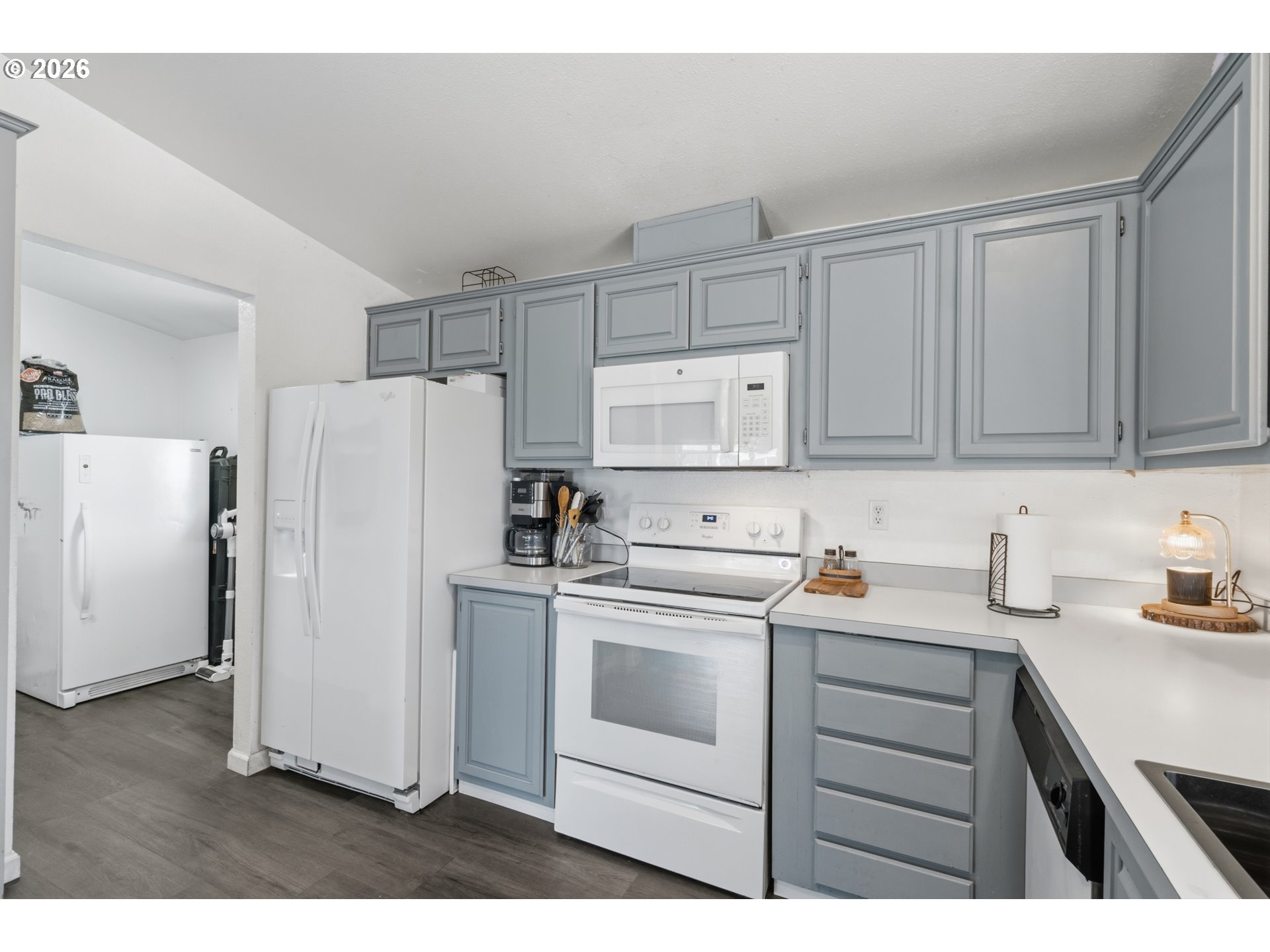 2151 Three Lakes Road Southeast Albany, OR 97322 - Photo 6 of 25 a kitchen with a refrigerator sink stove and cabinets