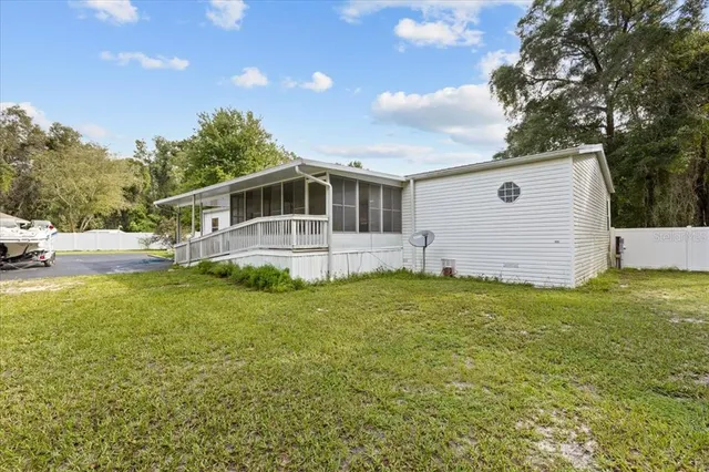a front view of house with yard and trees