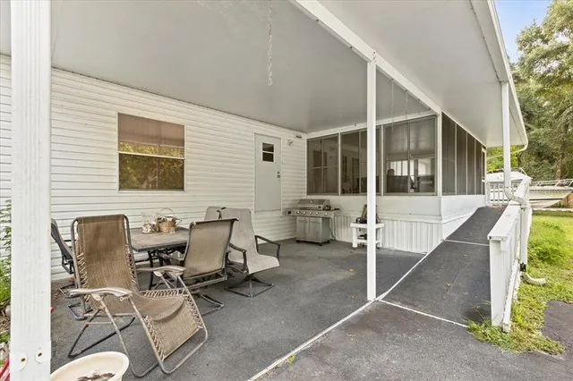 a building outdoor space with patio furniture and potted plants