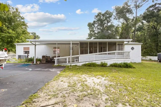 a view of a house with swimming pool and sitting area