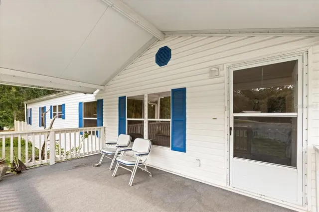 a view of a house with a porch and bench