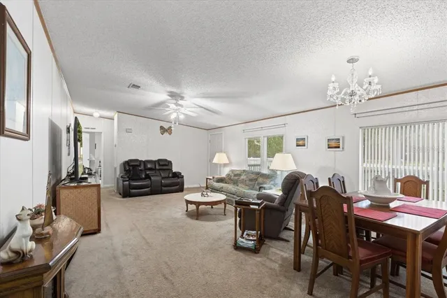 a view of a livingroom with furniture and a chandelier