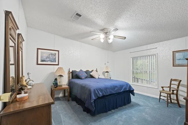 a living room with a bed furniture and a window